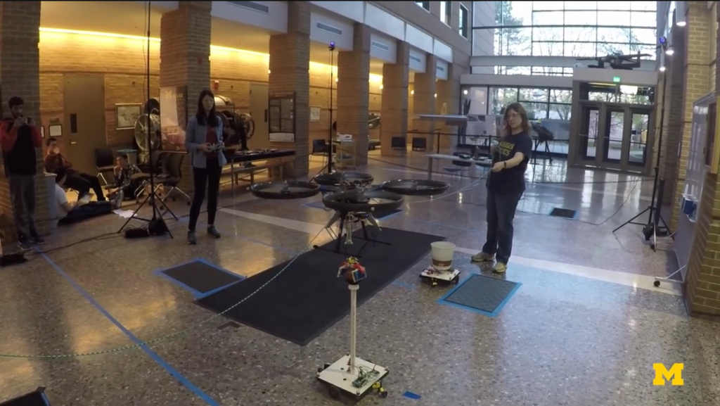 Real-world drone testing often relies on tethers or constrained environments to reduce risk. While effective to some extent, these setups limit performance and do not replicate true flight conditions. Drone testing using tethered setup in a real indoor lab environment, showing constrained flight conditions and limited control during development